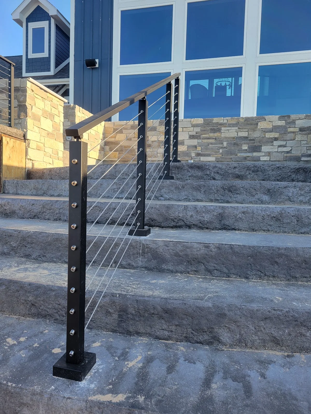 Cable railing installation on stone steps in Star Township MI