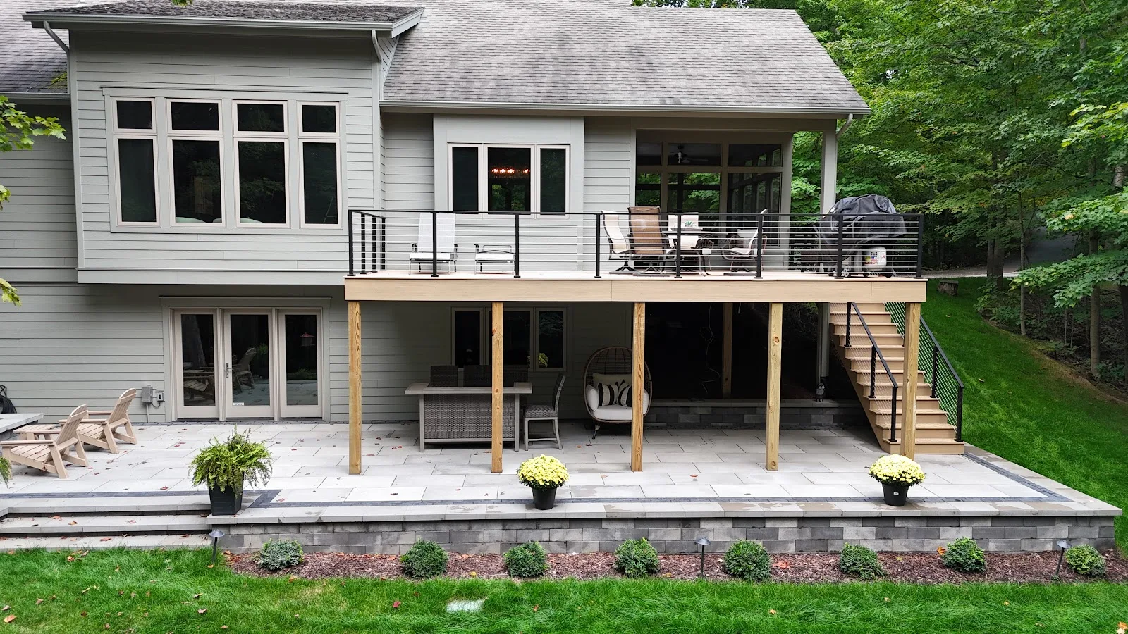 Elevated deck with cable railing in Central Lake Township