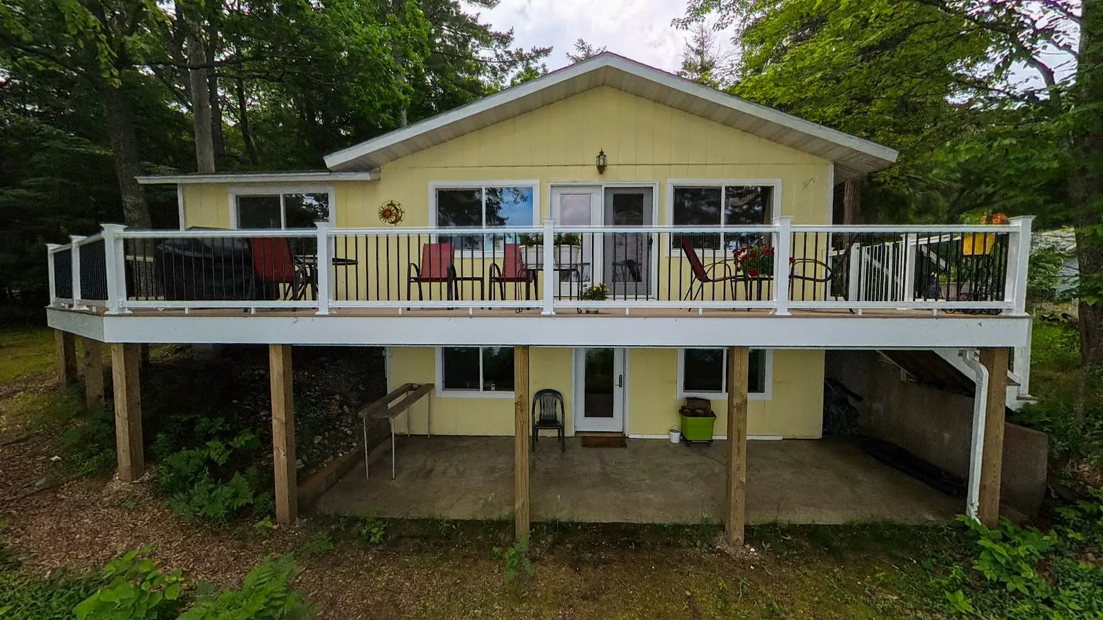 Elevated deck with white railing in Star Township MI