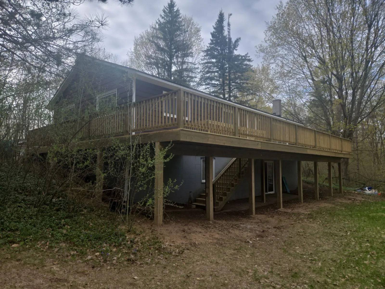 Elevated wood deck installation in Central Lake Township