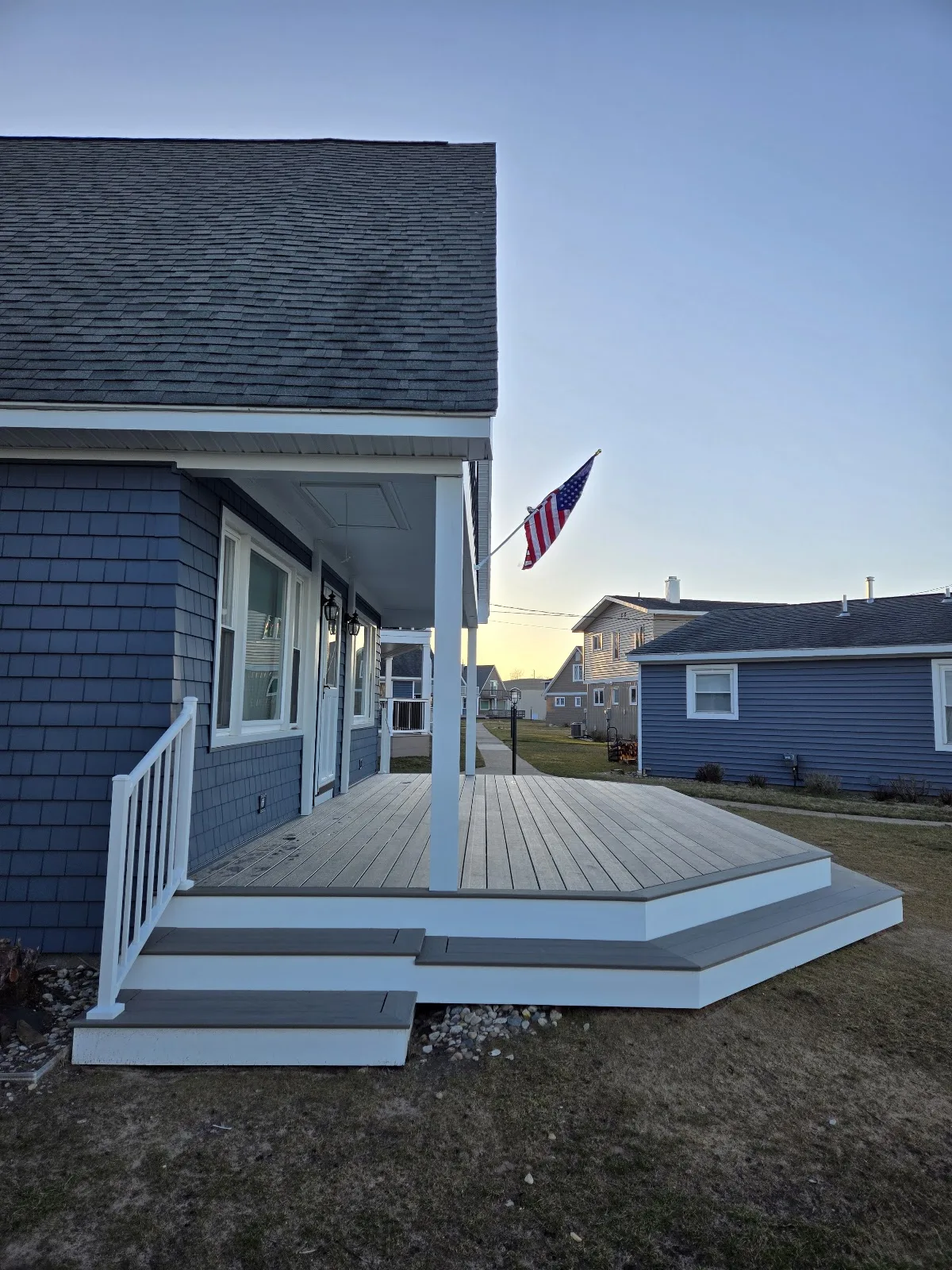 Grey composite porch deck installation in Star Township MI