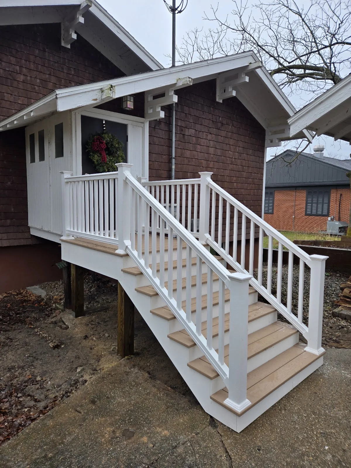 Composite deck stairs with white railings installed in Banks Township MI