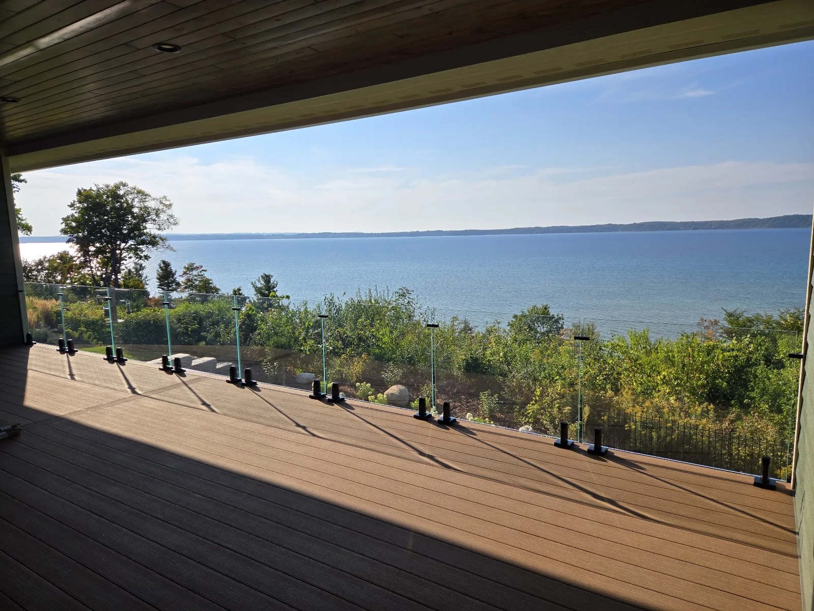 Covered composite deck overlooking water in Banks Township MI