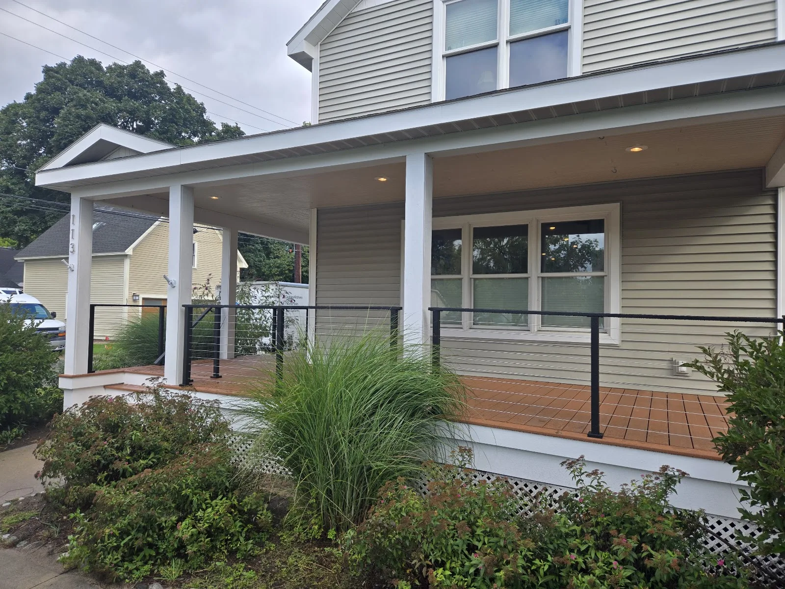 Covered porch with black railings in Ellsworth Township MI
